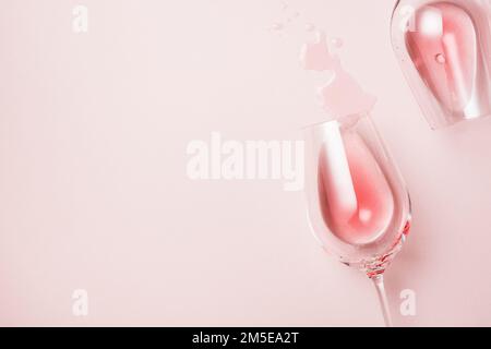 Two glasses of rose wine on a pink surface, top view. Stock Photo