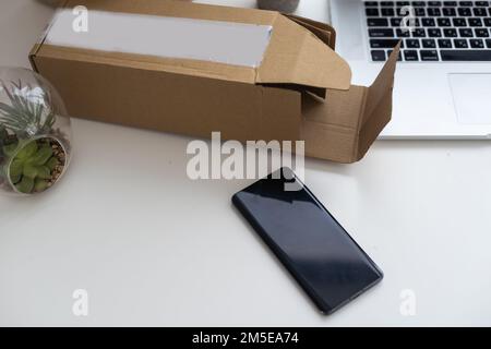 Shopping online e-comerce, Parcel boxes on a laptop. Stock Photo