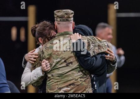 FORT KNOX, Ky. - Lt. Col. Sean McNichol hugs his Family goodbye prior to deployment to Germany, March 7. The V Corps main headquarters will deploy to provide additional command and control of U.S. Army forces in Europe. Stock Photo