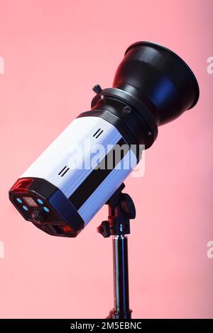 studio flash on a tripod and pink background Stock Photo
