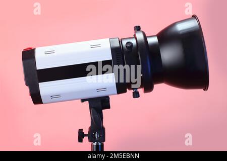 studio flash on a tripod and pink background Stock Photo