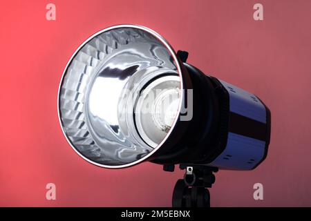 studio flash on a tripod and pink background Stock Photo