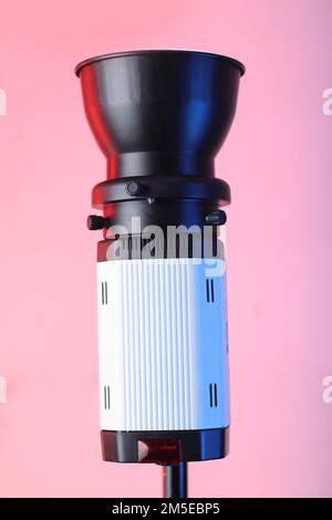 studio flash on a tripod and pink background Stock Photo