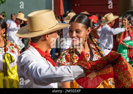 Dancers from Villa de San Juan Cacahuatepec dance the jarabe on the street during Guelaguetza in Oaxaca, Mexico.  The jarabe is a dance about courtshi Stock Photo