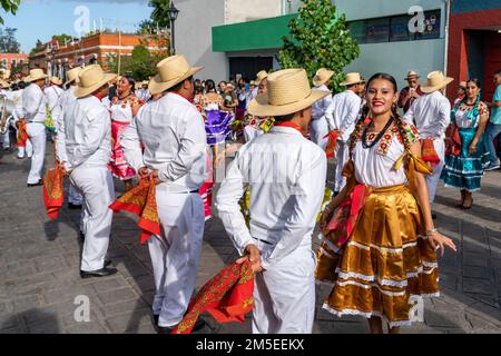 Dancers from Villa de San Juan Cacahuatepec dance the jarabe on the street during Guelaguetza in Oaxaca, Mexico.  The jarabe is a dance about courtshi Stock Photo