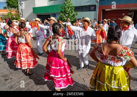 Dancers from Villa de San Juan Cacahuatepec dance the jarabe on the street during Guelaguetza in Oaxaca, Mexico.  The jarabe is a dance about courtshi Stock Photo