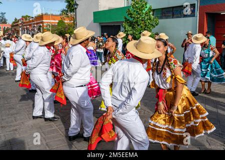 Dancers from Villa de San Juan Cacahuatepec dance the jarabe on the street during Guelaguetza in Oaxaca, Mexico.  The jarabe is a dance about courtshi Stock Photo