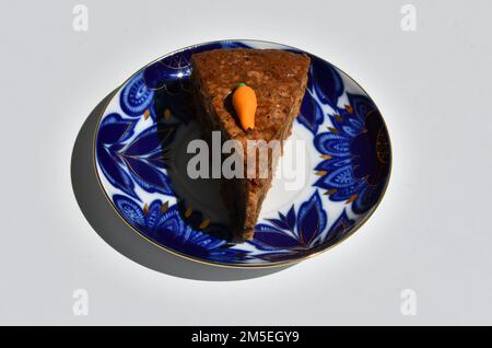 A piece of carrot cake on the coloured plate Stock Photo