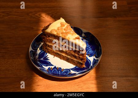 Piece of carrot cake on the coloured plate Stock Photo