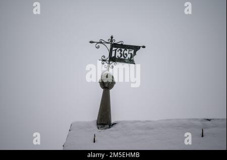 Rooftop ironwork date sign and weathervane inscribed with 1365 Stock Photo