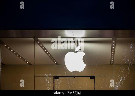 Illuminated Apple logo on the glass facade of Aix-en-provence Apple store, France. Stock Photo
