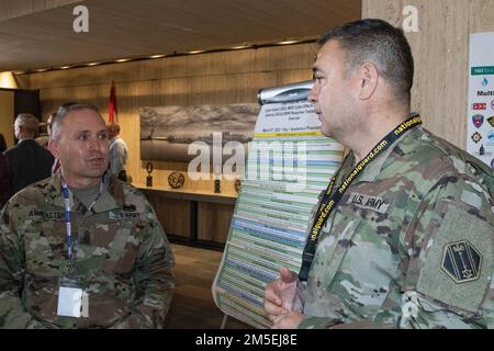 U.S. Army Command. Sgt. Maj. Jody Arrington, Command Sgt. Maj. of Task Force 46, Michigan National Guard, left, speaks with Maj. Gen. Pablo Estrada, commander of Task Force 46, outside the auditorium of a cyber exercise. From Mar. 8-10, 2022, the Cyber Impact exercise in Buffalo, New York, includes over 150 participants from 12 Army National Guard, two Army Reserve units, as well as local, state, federal, private sector, academic, and Canadian partners. The Michigan National Guard's 46th Military Police Command provides command and control to DoD service members who partner and train with civi Stock Photo