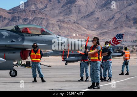 A Republic of Singapore Air Force airman, assigned to the 425th Fighter Squadron, Luke Air Force Base, Arizona, taxis-out an F-16 Fighting Falcon during Red Flag-Nellis 22-2 at Nellis Air Force Base, Nevada, March. 8, 2022. The 414th Combat Training Squadron conducts Red Flag exercises to provide aircrews the experience of multiple, intensive air combat sorties in the safety of a training environment. Stock Photo