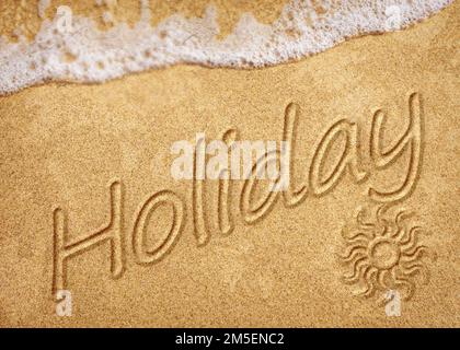 Word Holiday written on white sand beach. Summer holiday, travel and vacation concept. Abstract sea beach background Stock Photo