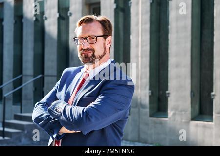 Portrait of a businessman with arms crossed outdoors Stock Photo
