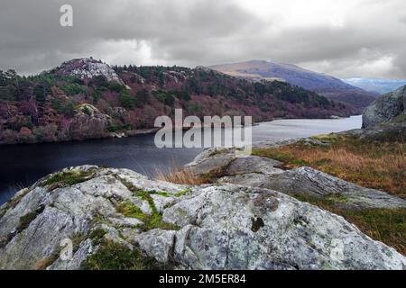 A view looking across Lake Padarn towards the Llanberis Pass from the rocky crag of Craig yr Undeb (Union Rock) in the Snowdonia National Park. Stock Photo