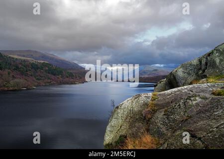 A view looking across Lake Padarn towards the Llanberis Pass from the rocky crag of Craig yr Undeb (Union Rock) in the Snowdonia National Park. Stock Photo