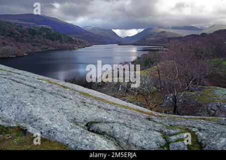 A view looking across Lake Padarn towards the Llanberis Pass from the rocky crag of Craig yr Undeb (Union Rock) in the Snowdonia National Park. Stock Photo