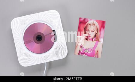 BlackPink BORN PINK 2nd Album collectible photo card with Rose on grey. Pink music CD in player. South Korean girl group BlackPink. Space for text. Ga Stock Photo