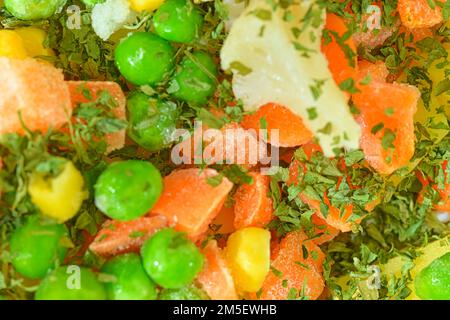 Close-up view of the soup vegetables with carrots, peas, cauliflower, corn and parsley. Texture of frozen soup vetetables. Frozen soup vegetables. Fro Stock Photo
