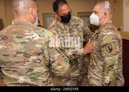 Col. Víctor A. Pérez, commander of Joint Task Force- Puerto R,ico pins Cpt. Luis E. Medina with the new rank of Major at Fort Buchanan, Puerto Rico, March 9, 2022. The Puerto Rico Army National Guard requires capable and effective officers to lead and instruct our soldiers in the day-to-day operations. Stock Photo