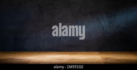 Wooden table or counter top with black stone wall background Stock Photo