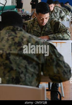 220310-N-GK686-1057 NAVAL AIR STATION SIGONELLA, Italy (Mar. 10,  2022) --  Aviation Boatswain’s Mate (Aircraft Handling) 2nd Class Gustavo Acevesmartinez takes the Navy-wide E-6 advancement examination on Naval Air Station Sigonella, March 10, 2022. NAS Sigonella’s strategic location enables U.S., allied, and partner nation forces to deploy and respond as required to ensure security and stability in Europe, Africa and Central Command. Stock Photo