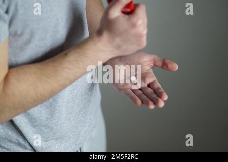 Dry male hands. Man putting hand cream on his dry hands. Stock Photo