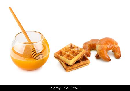 Honey, croissant and waffles isolated on white background. Stock Photo