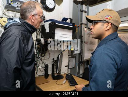 NORFOLK, Va. (Mar. 10, 2022) – Ensign Manuel Roaovalles, right, gives a tour of damage control central while aboard the Arleigh Burke-class guided-missile destroyer USS Porter (DDG 78), Mar. 10, 2022. Porter, forward-deployed to Rota, Spain, is currently underway in the U.S. 2nd Fleet area of operations to conduct routine certifications and training. Stock Photo