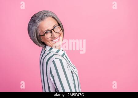 Profile photo of cheerful smiling optimistic satisfied pensioner businesswoman wear glasses enjoy management job isolated on pink color background Stock Photo