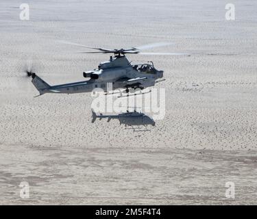 An AH-1Z Viper (top) with Marine Operational and Test Evaluation Squadron 1 (VMX-1), and an MQ-8C Fire Scout unmanned helicopter assigned to Helicopter Sea Combat Squadron 23 (HSC-23), conduct Strike Coordination and Reconnaissance Training near El Centro, California, March 10, 2022. The purpose of this exercise was to provide familiarization and concept development of manned-unmanned teaming.