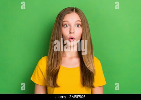 Photo of shocked speechless person pouted lips staring cant believe isolated on green color background Stock Photo