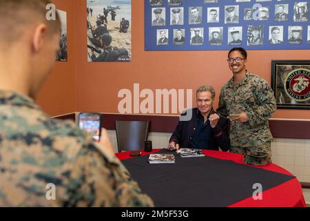 Martin Kove takes a photo with U.S. Marine Sgt. Markus Madrona, a section leader with Combined Anti-Armor Team 1, 3rd Battalion, 5th Marine Regiment, 1st Marine Division, during a signing at the 62 Area mess hall on Marine Corps Base Camp Pendleton, California, March 9, 2022. Martin Kove, the actor who played John Kreese in the Karate Kid franchise, came onto base to do a meet and greet with the Marines in the 62 Area. Madrona is a native of Spanaway, Washington. Stock Photo