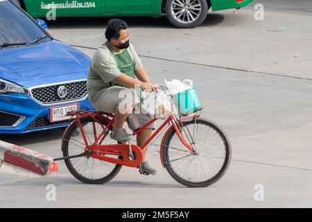 SAMUT PRAKAN, THAILAND, FEB 23 2022, A man ride on a bicycle at city street. Stock Photo