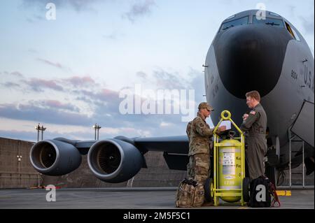 U.S. Airmen from the 190th Air Refueling Wing conduct preflight checks on a KC-135 Stratotanker assigned to the 117th Air Refueling Squadron, Forbes Field Air National Guard Base, Kansas, currently stationed at Kadena Air Base, Japan, March 10, 2022. The KC-135 Stratotanker can hold up to 200,000 pounds of fuel, which is pumped through the tanker’s flying boom and utilized mid-flight to refuel a variety of aircraft thus extending its global reach to maintain a free and open Indo-Pacific. Stock Photo