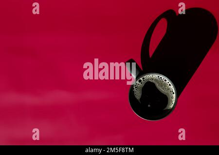 top view of cup of black coffee on magenta background with copy space Stock Photo