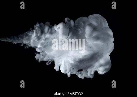 Close up shot of paint cloud spraying on a black background. Stock Photo