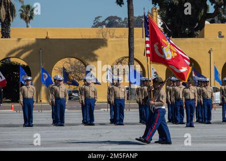 The Marine Corps Recruit Depot San Diego Color Guard present the colors during a graduation ceremony for Echo Company, 2nd Recruit Training Battalion, at Marine Corps Recruit Depot San Diego, March 11, 2022. The new Marines stood at attention while colors were marched in front of them. Stock Photo