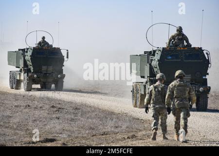 U.S. Soldiers, assigned to 3rd Battalion, 321st Field Artillery Regiment, 18th Field Artillery Brigade, maneuver M142 High Mobility Artillery Rocket Systems during a combined live fire exercise with 41st Field Artillery Brigade at the 7th Army Training Command’s Grafenwoehr Training Area, Germany, March 11, 2022. The deployment of U.S. forces here is a prudent measure that underpins NATO’s collective war-prevention aims, defensive orientation and commitment to protect all Allies. Stock Photo