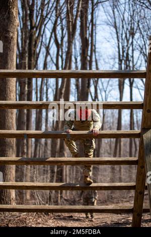 U.S. Army Staff Sgt. Paul Suh, of the 104th Medical Company Area Support, 1297th Combat Sustainment Support Battalion, undergoes the obstacle course event at the 2022 Maryland Best Warrior Competition on March 11, 2022 at H. Steven Blum Military Reservation, Glen Arm, Maryland. Throughout the competition, service members from the Maryland Army National Guard and the Estonian Defence Force were tested on their knowledge of essential soldier skills along with mental and physical limits during the competition events that included a ruck march, a warrior task lane, a stress shoot event, obstacle c Stock Photo
