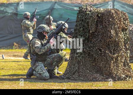 Albanian Special Forces soldiers exhibit their rifle marksmanship during a military demonstration at the Albanian Special Forces Headquarters in Albania, March 11th, 2022. Special Operations Command Europe recently made the decision to locate a forward-based SOF headquarters, on a rotational basis, in Albania with the HQ being focused on SOF command and control of SOCEUR’s engagements in the region, coordination of Joint Combined Exchange Training engagements, and Civil Military Support Element engagement planning. Stock Photo