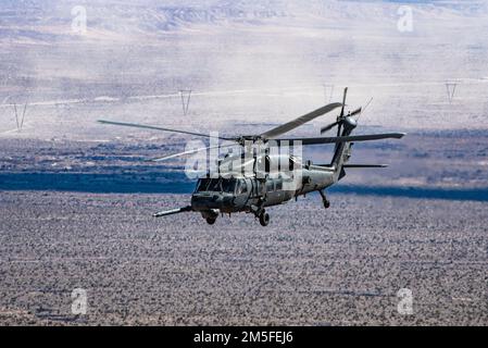 An HH-60 Pave Hawk assigned to the 55th Rescue Squadron, participates in a combat search and rescue exercise during Red Flag-Nellis 22-2, at the Nevada Test and Training Range, March 10, 2022. The Nevada Test and Training Range is the U.S. Air Force’s premier military training area with more than 12,000 square miles of airspace and 2.9 million acres of land. Stock Photo