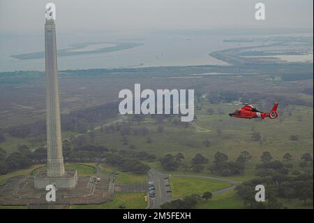 Coast Guard Air Station Houston performs an area of responsibility formation flight over the San Jacinto Monument in La Porte, Texas, March 11, 2022. The air station regularly conducts AOR runs to keep crews familiar with the area. Stock Photo