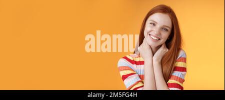 Silly enthusiastic attractive redhead blue-eyed girl tilting head touching neck flirty smiling enjoy perfect day feel happiness joy giggling Stock Photo