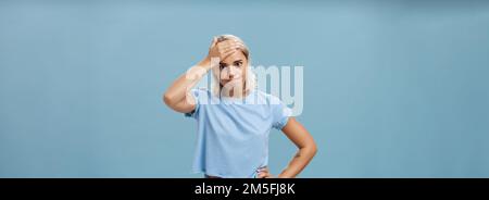 Girl cannot deal with naughty kids being left alone while mom on shopping holding hand on forehead breathing out losing temper being in troublesome Stock Photo