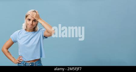 Girl cannot deal with naughty kids being left alone while mom on shopping holding hand on forehead breathing out losing temper being in troublesome Stock Photo