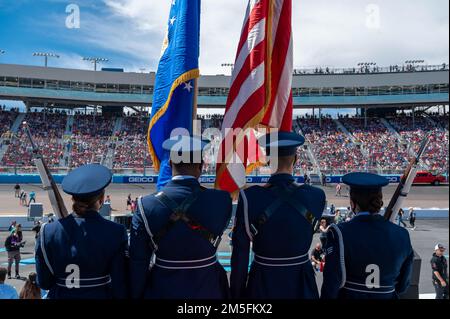 Members of the Luke Air Force Base Honor Guard prepare to present colors during the national anthem before the NASCAR Ruoff Mortgage 500 March 13, 2022, at the Phoenix Raceway, Arizona. The ceremony was held in front of a sold out stadium that kicked off the event. Ceremonies like these are a part of community initiatives that allow Airmen to showcase long-standing traditions and U.S. Air Force heritage to the local community. Stock Photo