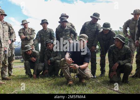 U.S. Army Sgt. Johnathan Brennan, an infantryman assigned to Headquarters and Headquarters Company, 2nd Battalion, 27th Infantry Regiment, 25th Infantry Division, demonstrates to a class of U.S. and Philippine Army Soldiers how to set up a z-pulley during the Jungle Operations Training Course during Salaknib 2022 at Fort Magsaysay, Nueva Ecija, Philippines, March 14, 2022. The Jungle Operations Training Course was held to prepare soldiers from both nations for the jungle terrain they may encounter around the Indo-Pacific, building on Salaknib’s mission of increasing combined readiness and inte Stock Photo