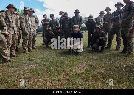 U.S. Army Sgt. Johnathan Brennan, an infantryman assigned to Headquarters and Headquarters Company, 2nd Battalion, 27th Infantry Regiment, 25th Infantry Division, demonstrates to a class of U.S. and Philippine Army Soldiers how to set up a z-pulley during the Jungle Operations Training Course during Salaknib 2022 at Fort Magsaysay, Nueva Ecija, Philippines, March 14, 2022. The Jungle Operations Training Course was held to prepare soldiers from both nations for the jungle terrain they may encounter around the Indo-Pacific, building on Salaknib’s mission of increasing combined readiness and inte Stock Photo